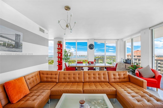 living room featuring visible vents and a notable chandelier