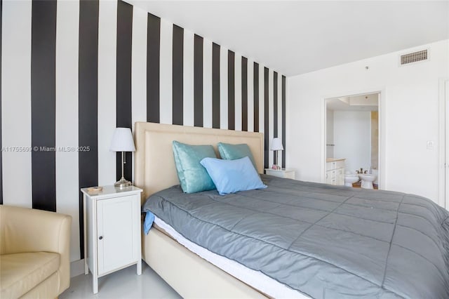 bedroom featuring ensuite bathroom and visible vents