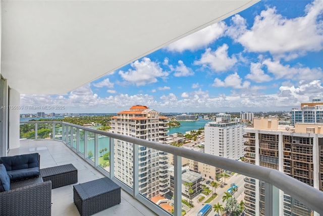 balcony with a view of city and a water view