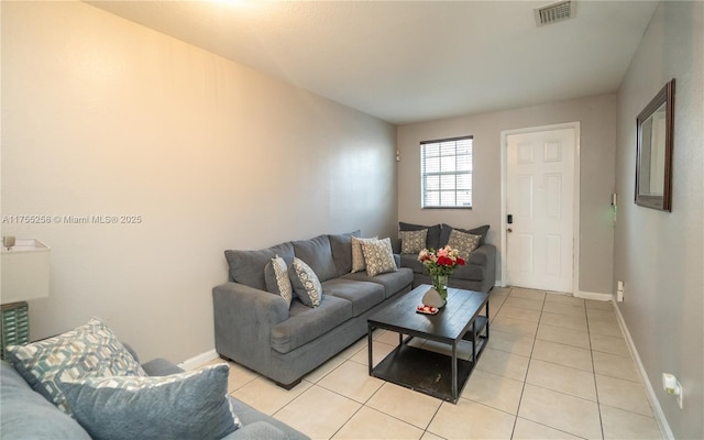 living area with visible vents, baseboards, and light tile patterned floors