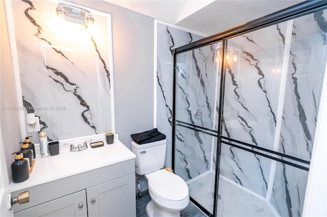 full bathroom with toilet, a marble finish shower, and vanity