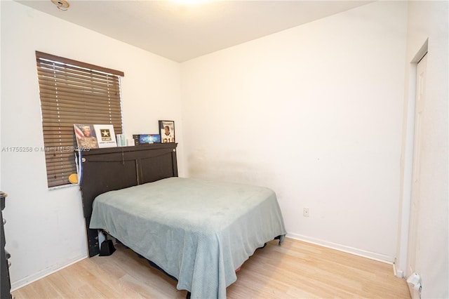 bedroom featuring baseboards and light wood-style floors