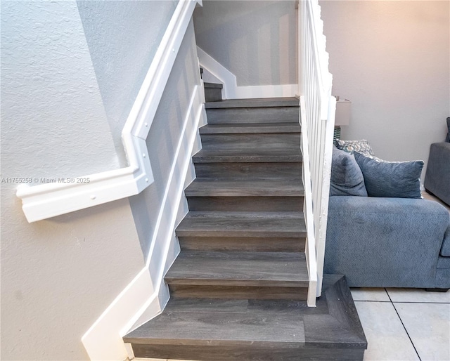 stairs featuring tile patterned flooring