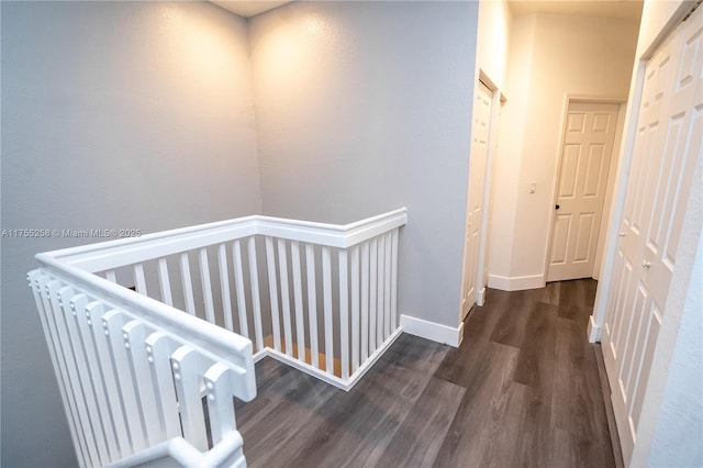 hallway with baseboards and wood finished floors