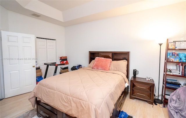 bedroom with visible vents and light wood-style flooring