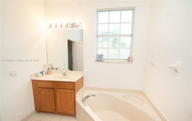 full bath with a garden tub, vanity, and tile patterned floors