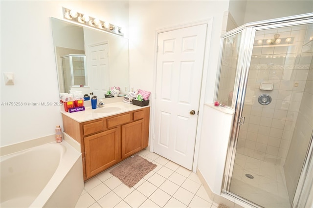 full bath featuring a garden tub, a shower stall, tile patterned flooring, and vanity