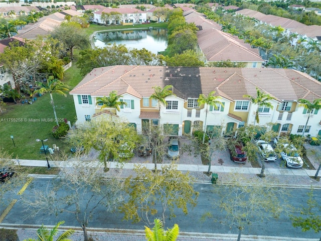 birds eye view of property featuring a residential view and a water view