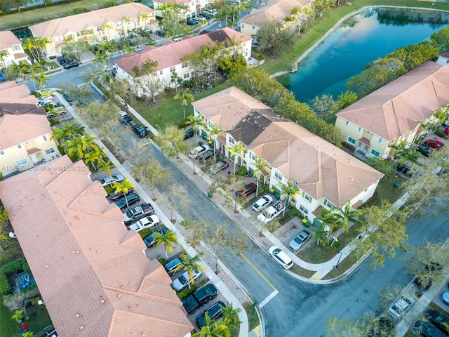 birds eye view of property featuring a water view and a residential view