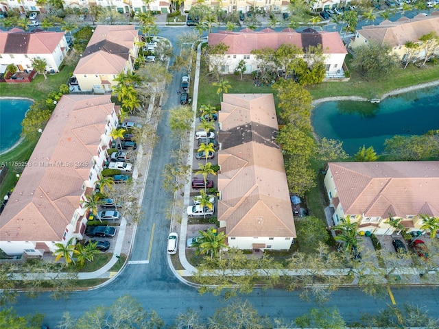 birds eye view of property featuring a water view and a residential view