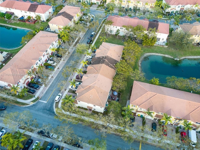 drone / aerial view featuring a water view and a residential view