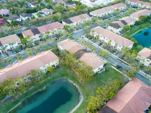 drone / aerial view featuring a water view and a residential view