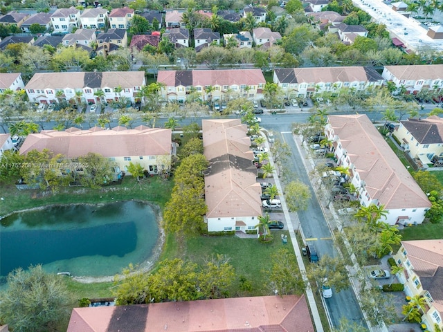 drone / aerial view with a water view and a residential view