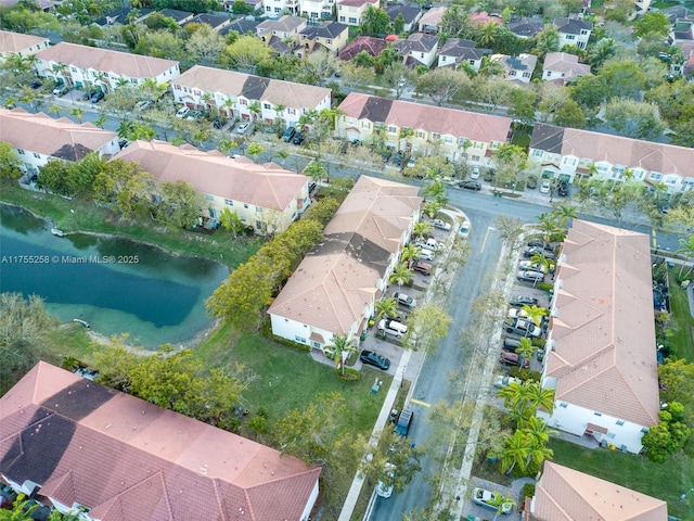 drone / aerial view with a water view and a residential view