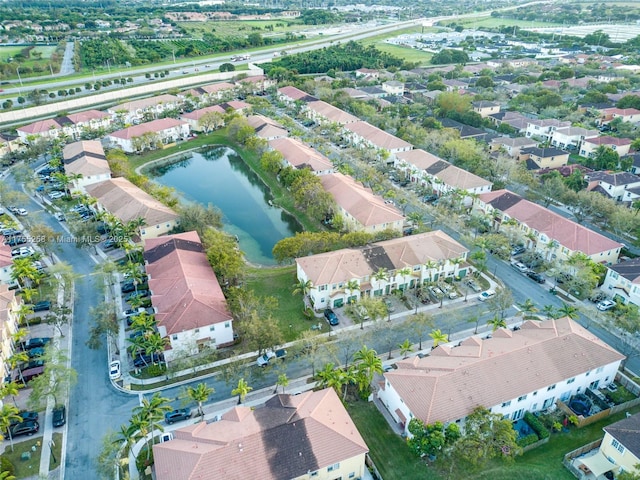 drone / aerial view featuring a water view and a residential view