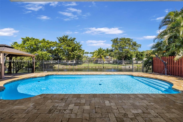 view of pool with a patio area, fence, a fenced in pool, and a gazebo