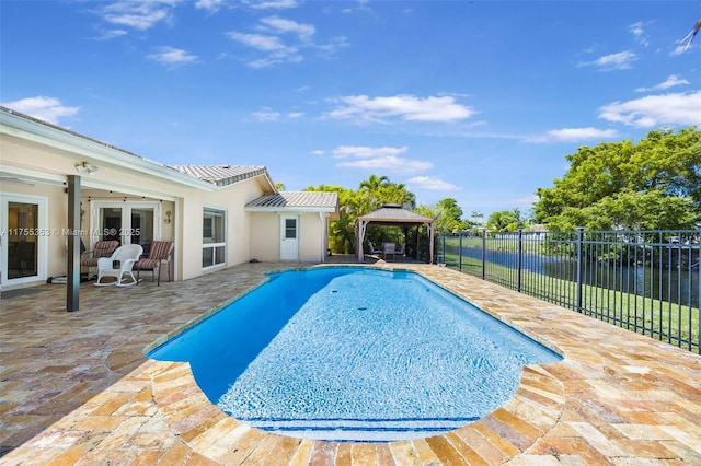 view of swimming pool with a patio area, fence, french doors, and a gazebo