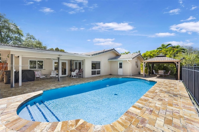 view of swimming pool with a fenced in pool, a patio, ceiling fan, fence, and a gazebo