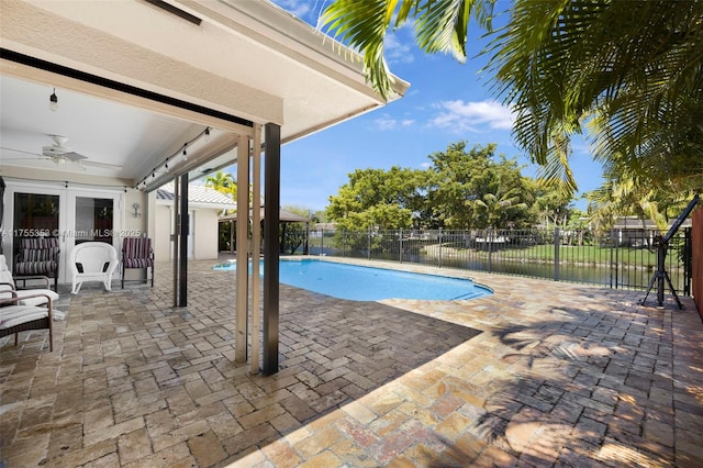 view of swimming pool featuring ceiling fan, fence, french doors, a fenced in pool, and a patio area