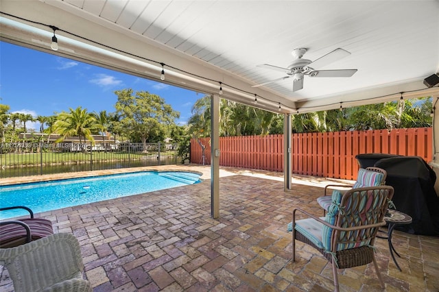 exterior space featuring a fenced in pool, a fenced backyard, ceiling fan, and area for grilling