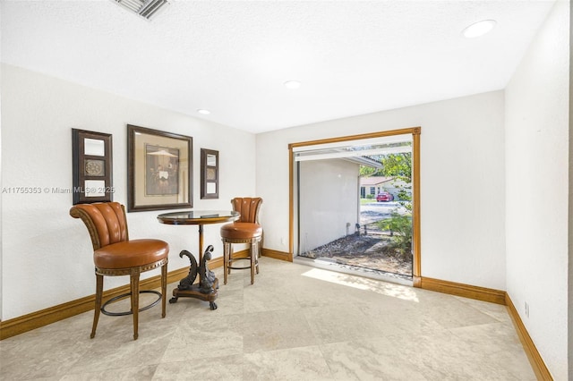sitting room with recessed lighting, visible vents, and baseboards