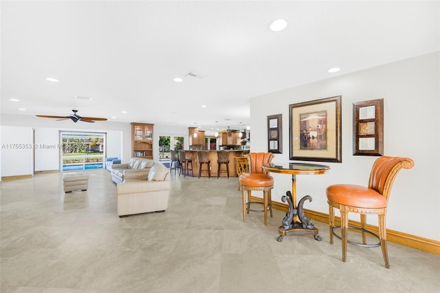 living room with recessed lighting, a ceiling fan, and baseboards