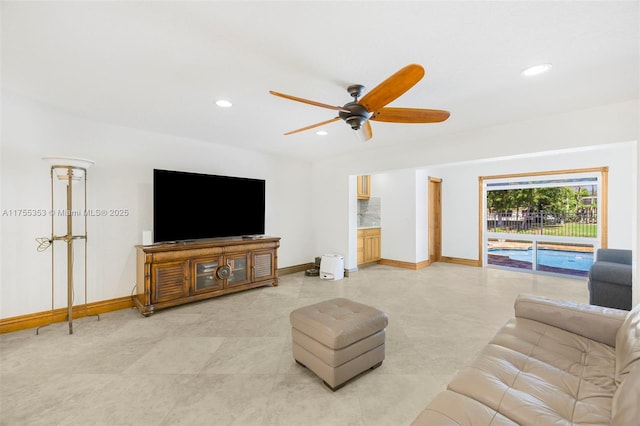 living room featuring recessed lighting, a ceiling fan, and baseboards