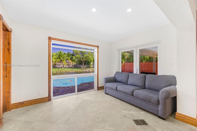 living area with french doors, recessed lighting, visible vents, and baseboards