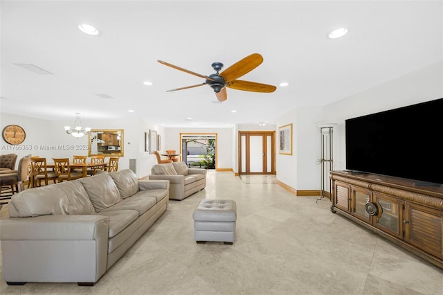 living room with ceiling fan with notable chandelier, baseboards, and recessed lighting
