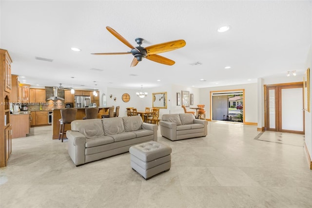 living room with visible vents, ceiling fan with notable chandelier, and recessed lighting