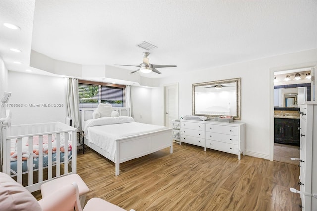 bedroom featuring recessed lighting, visible vents, light wood-style flooring, a ceiling fan, and a textured ceiling