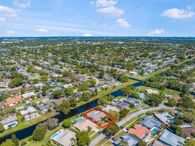 birds eye view of property with a water view and a residential view