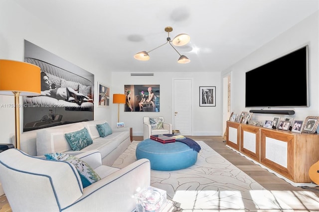 living area featuring baseboards and wood finished floors