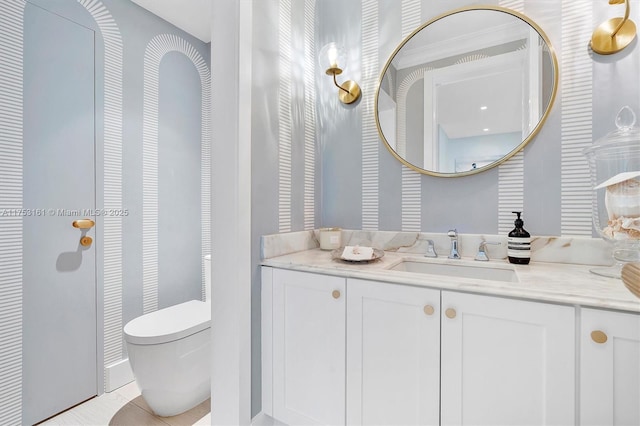 bathroom with toilet, tile patterned floors, and vanity