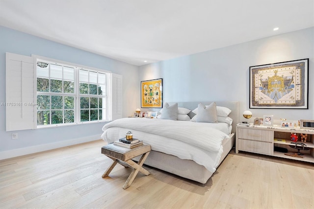 bedroom with light wood finished floors, baseboards, and recessed lighting