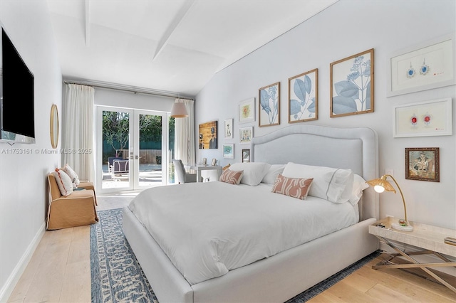 bedroom with light wood finished floors, lofted ceiling, baseboards, and access to outside