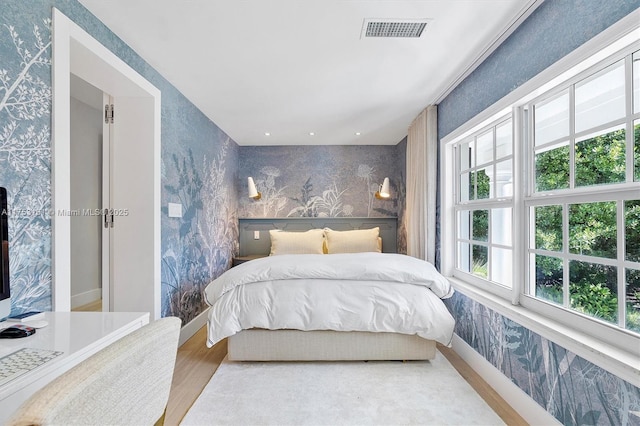 bedroom featuring visible vents, recessed lighting, wallpapered walls, and wood finished floors