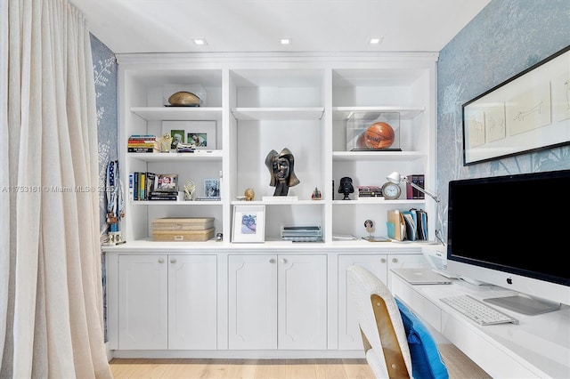 office featuring light wood-type flooring and built in features