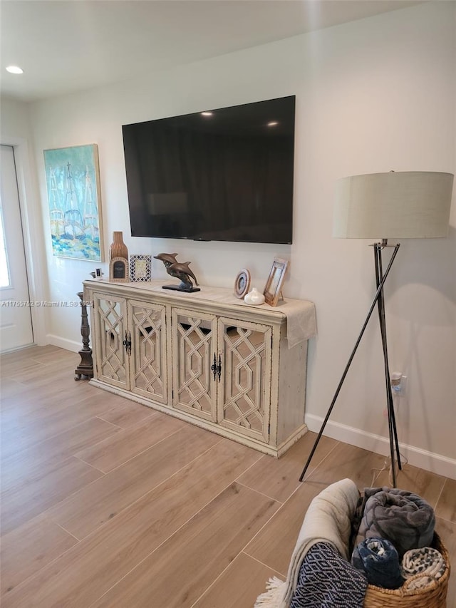 interior space with light wood-type flooring, baseboards, and recessed lighting