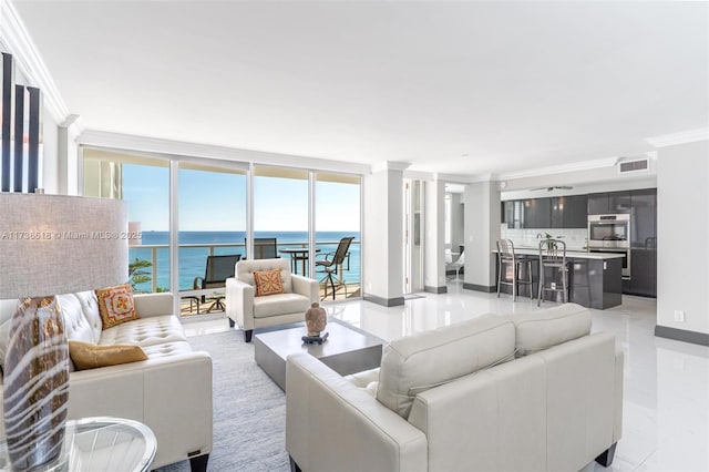 living area featuring baseboards, ornamental molding, visible vents, and a water view