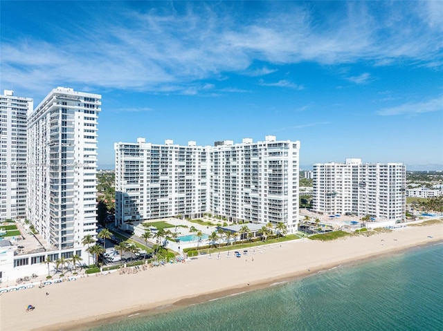 aerial view featuring a water view, a city view, and a view of the beach