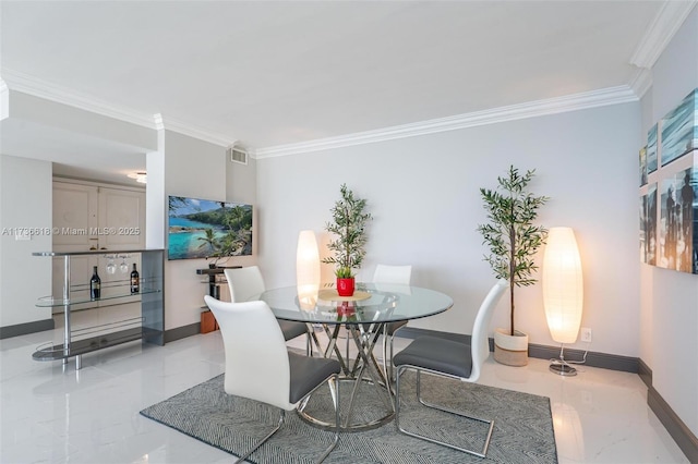 dining room featuring marble finish floor, baseboards, and ornamental molding