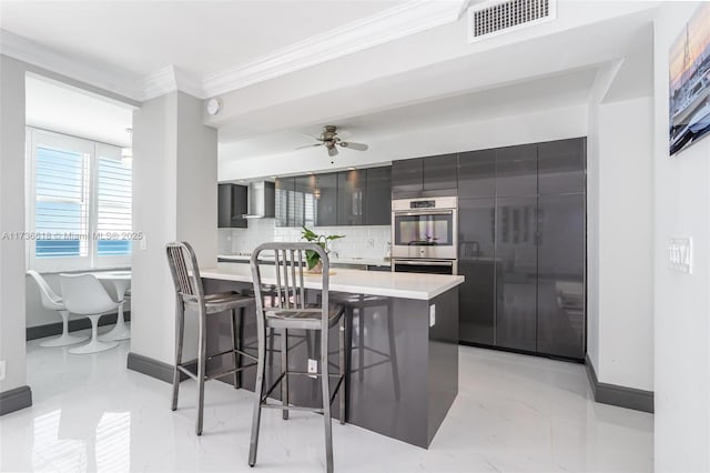 kitchen with visible vents, a kitchen bar, stainless steel double oven, modern cabinets, and crown molding