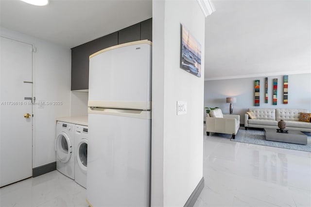 clothes washing area featuring independent washer and dryer, marble finish floor, and baseboards