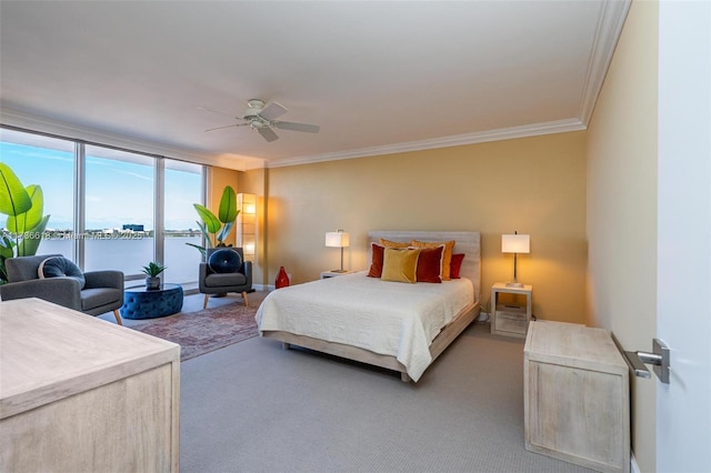bedroom featuring a ceiling fan, carpet flooring, a water view, and ornamental molding