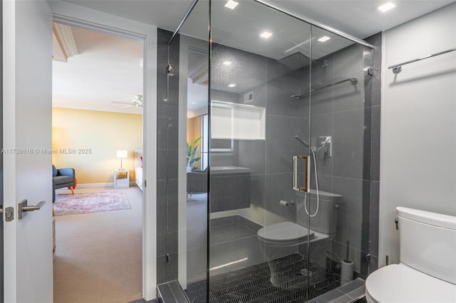 full bathroom with a shower stall, ceiling fan, and toilet