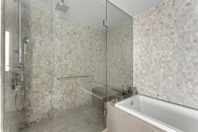 68 SE 6th St Unit 3506, Miami, FL 33131 - full bathroom with a stall shower, a bath, and tile walls