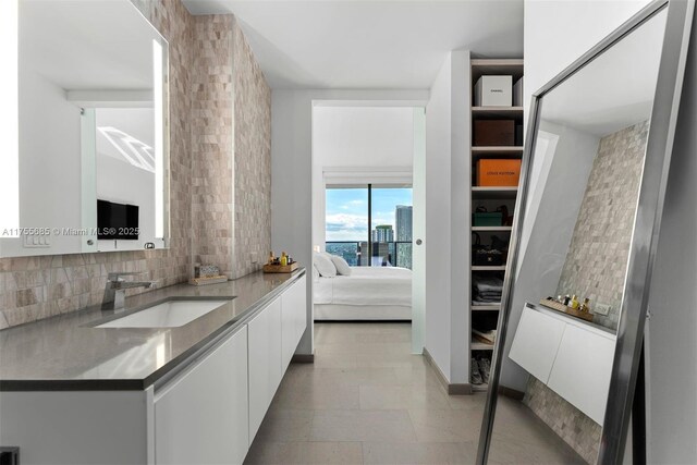 68 SE 6th St Unit 3506, Miami, FL 33131 - interior space with white cabinets, a sink, backsplash, and modern cabinets