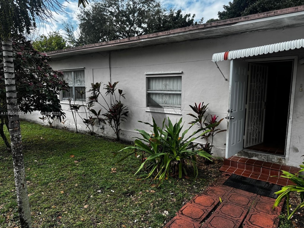 view of property exterior featuring a lawn and stucco siding