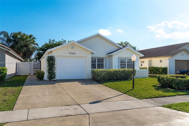 ranch-style home with an attached garage, fence, driveway, stucco siding, and a front yard